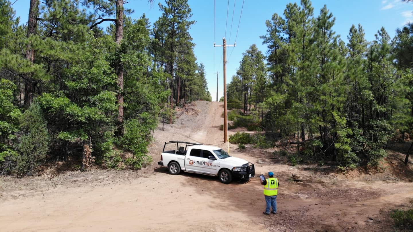 Firmatek employee and truck in forest